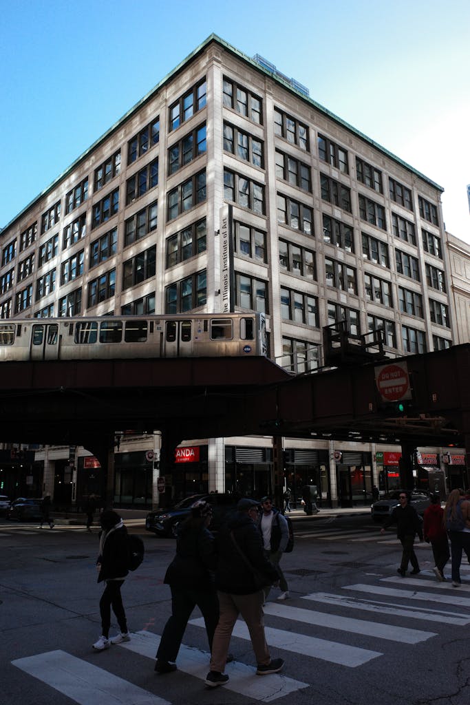 A large building with a train crossing the street